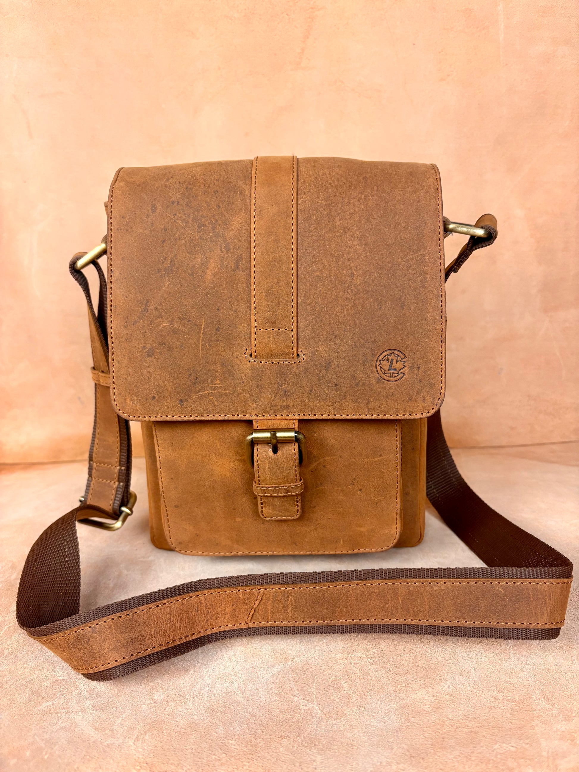 Masih Studio Arman Crest leather shoulder bag with buckle closure.