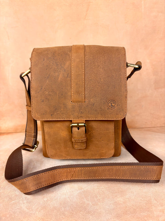 Masih Studio Arman Crest leather shoulder bag with buckle closure.