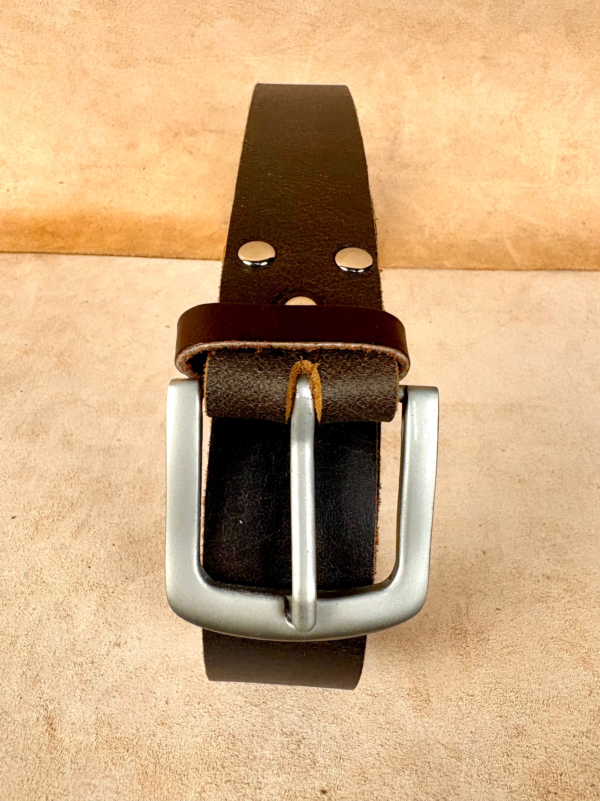 dark brown leather belt with silver buckle