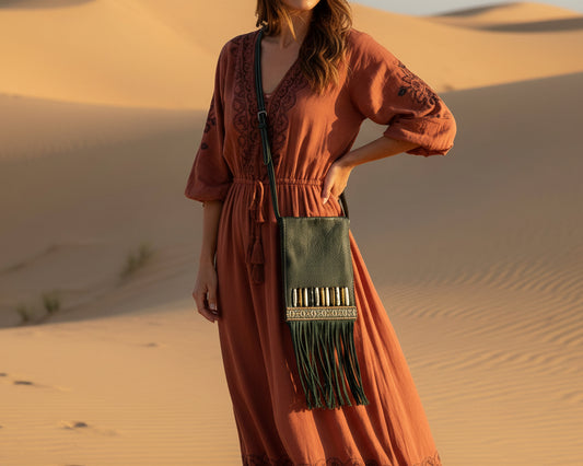 Front view of the Nomad Trail leather crossbody bag in forest green with decorative beads and long leather fringe

Close-up of bead decoration and woven textile detail on the Nomad Trail forest green leather bag

Lifestyle image of the Nomad Trail forest green leather fringe crossbody bag worn crossbody