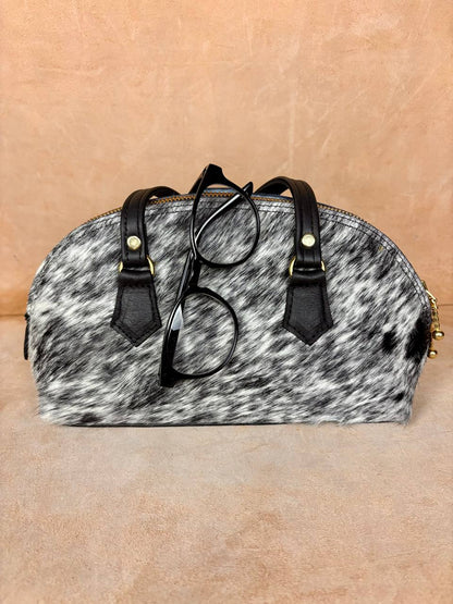 Nomad Arc spotted pony hair bag side view with zipper and strap