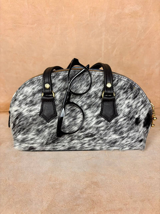 Nomad Arc spotted pony hair bag side view with zipper and strap